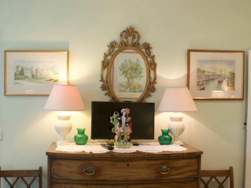 Pictures hanging up on the wall, with lamps