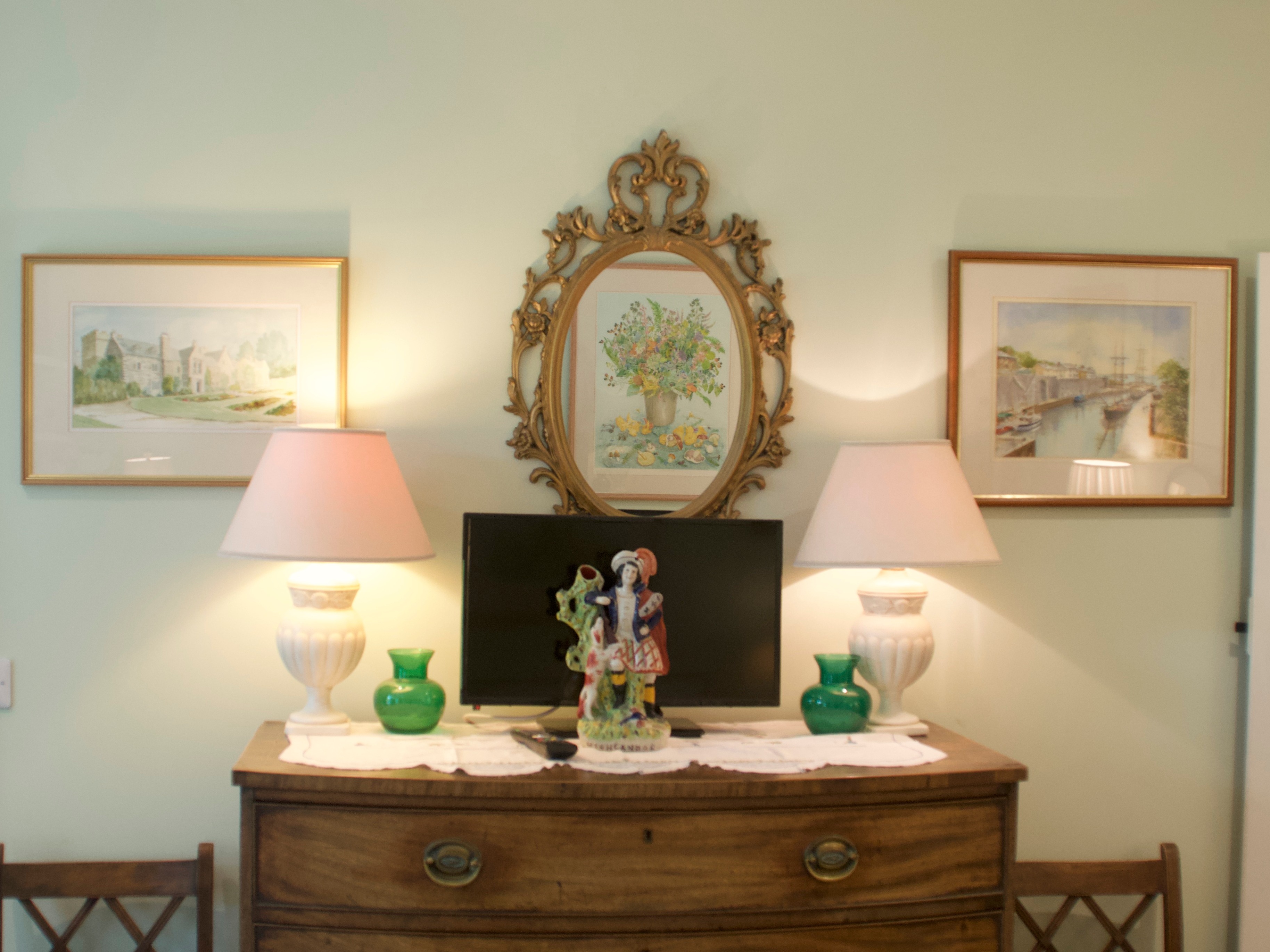 Pictures hanging up on the wall, with lamps